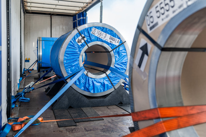 Recycled plastic cradle for safe steel coil transport on flatbed semi-trailer