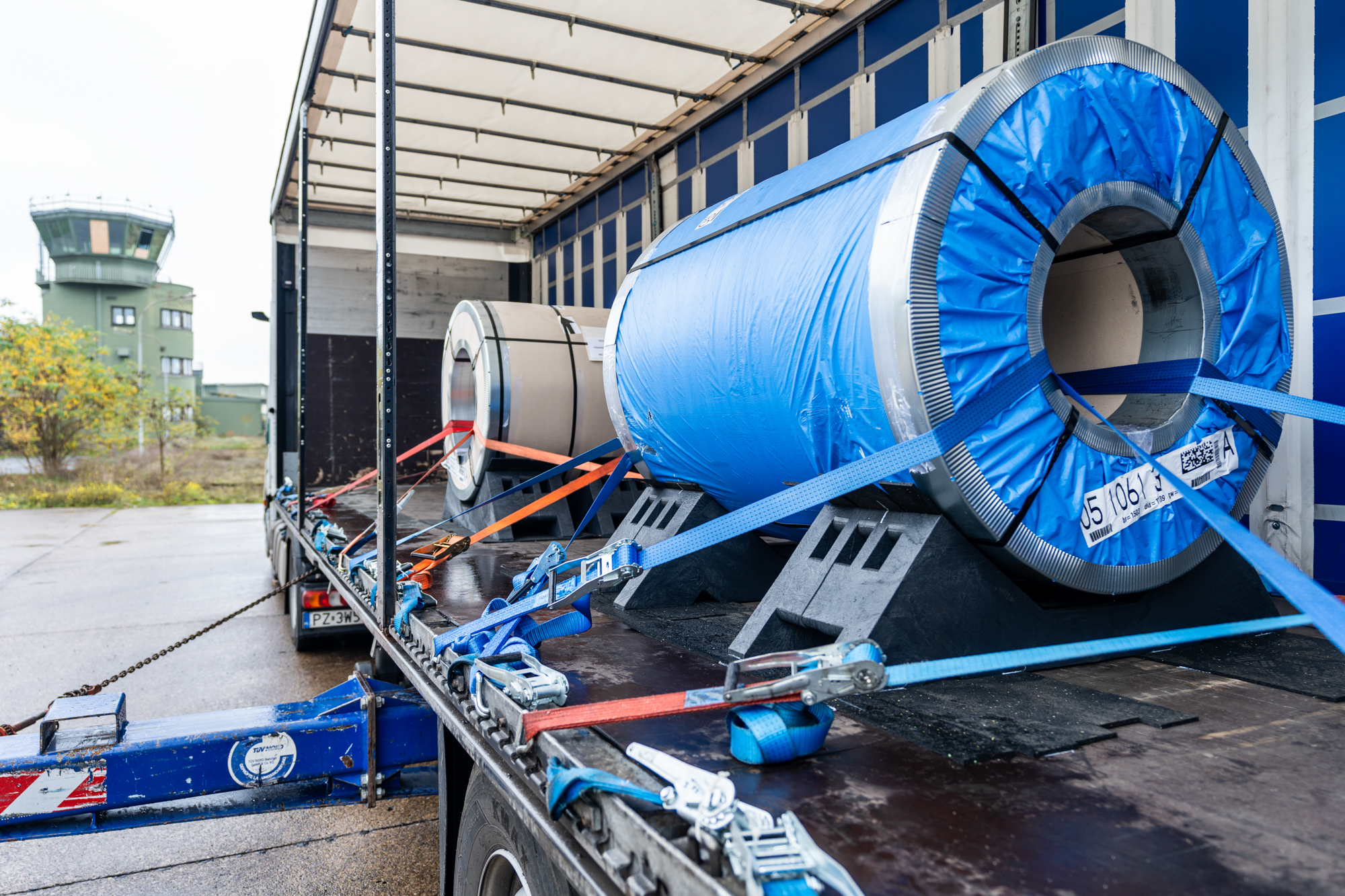 KLP® Coil Transport Cradle securing steel coils on flatbed semi-trailer