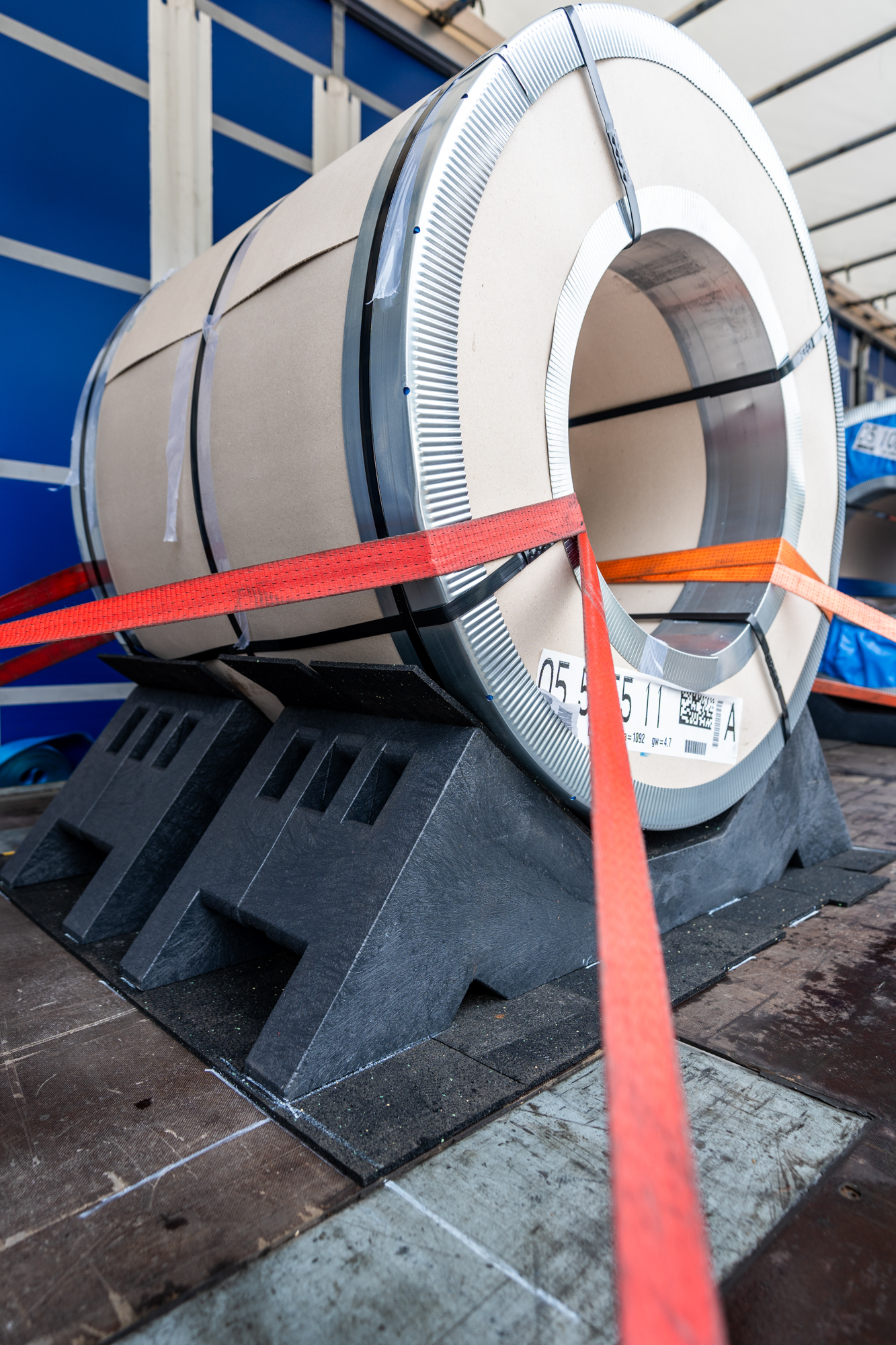 Recycled plastic cradle for safe steel coil transport on flatbed semi-trailer